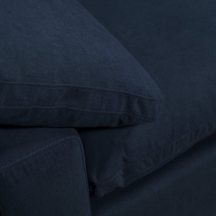 Sofa sectionnel modulaire Eclipse 4 pièces en tissu d’apparence lin avec pouf et coussins réversibles en duvet et plumes - bleu marine